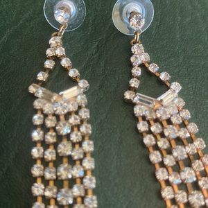 Rhinestone and gold colored stud earrings with dangle rhinestones